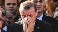 EDITORS NOTE: Graphic content / Turkey's President Recep Tayyip Erdogan (C) reacts after attending the funeral of a victim of the coup attempt in Istanbul on July 17, 2016. Turkish President Recep Tayyip Erdogan vowed today to purge the "virus" within state bodies, during a speech at the funeral of victims killed during the coup bid he blames on his enemy Fethullah Gulen. / AFP / BULENT KILIC (Photo credit should read BULENT KILIC/AFP/Getty Images)