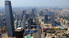 This aerial photo shows the CCTV headquarters building (C) being built in downtown Beijing on August 2, 2008 ahead of the Beijing 2008 Olympic Games. Costing some 800 million USD to build, the CCTV building reportedly is the most expensive building in the world. AFP PHOTO / GOH CHAI HIN / AFP / GOH CHAI HIN